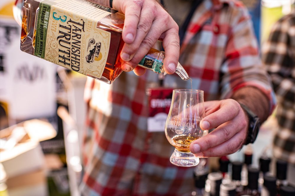 pouring bourbon into a glass