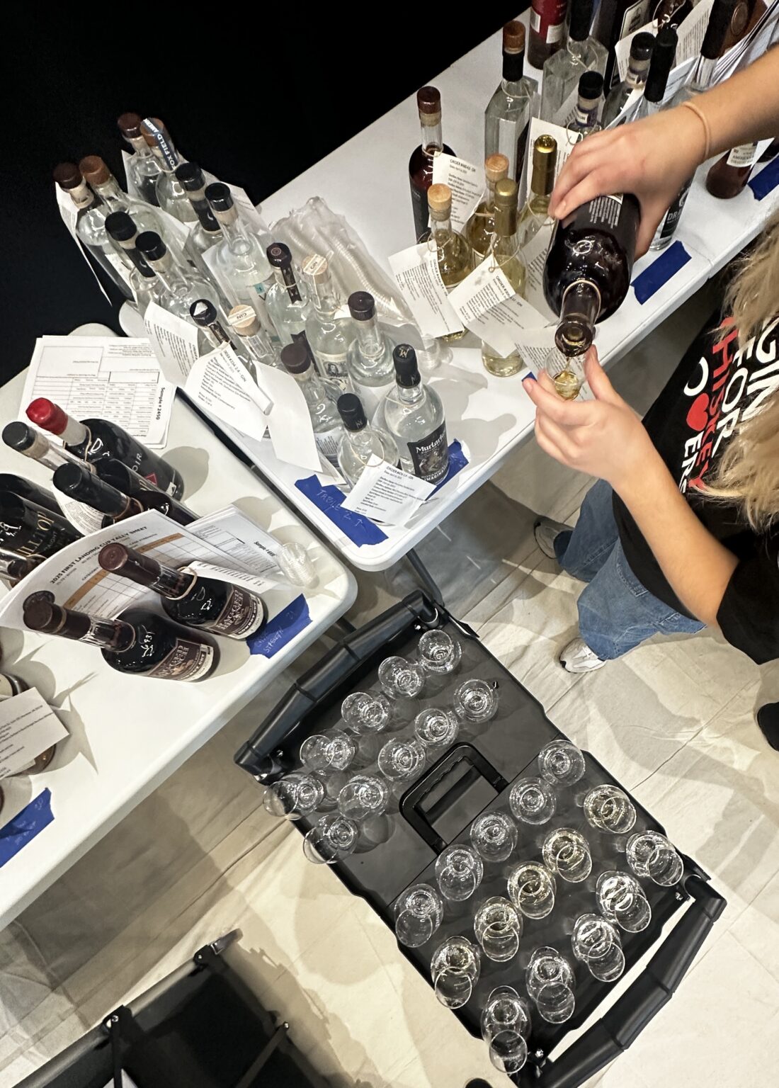 a steward fills a tasting glass with Virginia spirits at the First Landing Cup